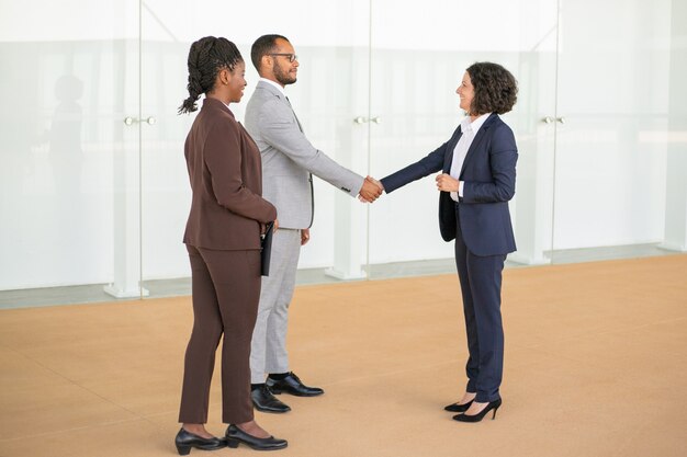 Friendly business colleagues greeting each other