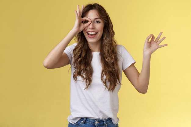 Friendly charismatic enthusiastic happy woman having perfect day show okay ok circle gesture look th...