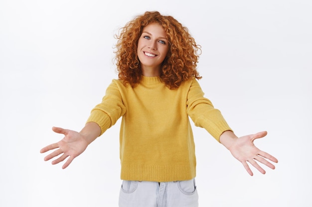 Friendly, cheerful attractive ginger girl, redhead curly-haired female embrace you, want to hug or cuddle someone