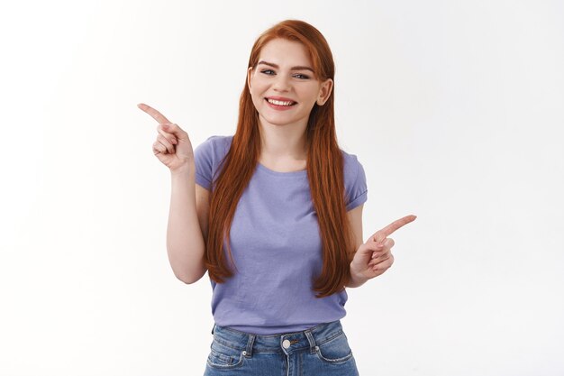 Friendly, cheerful and outgoing smiling cute woman with long red hair, pointing sideways, showing left and right banners, invite check out links, promote products, two variants, white wall