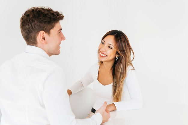 Friendly colleagues laughing in bright office