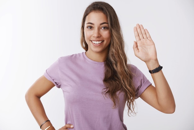 Friendly confident happy girl waving hand saying hello