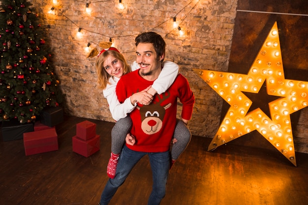 Friendly couple in front of christmas star decoration