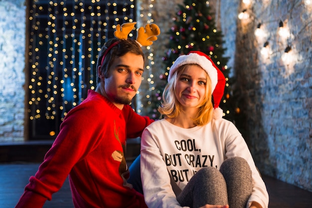 Friendly couple in front of christmas tree