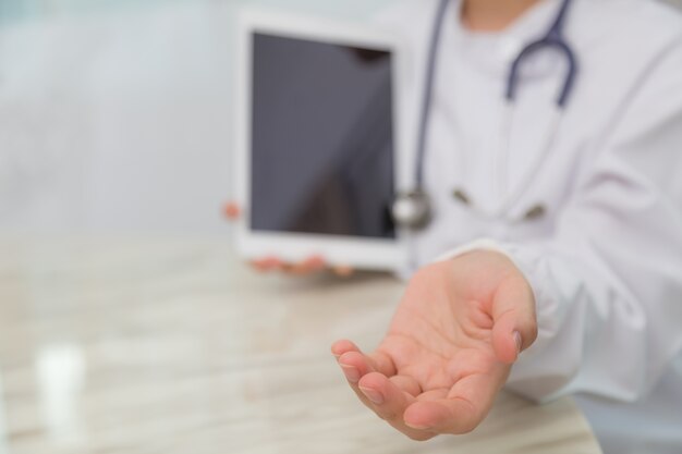 Friendly doctor with tablet