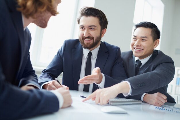 Friendly executives pointing to a report