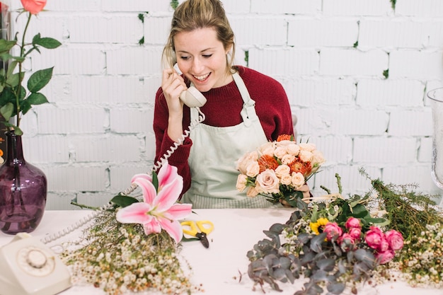 Friendly florist speaking on phone