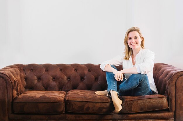 Friendly woman on sofa