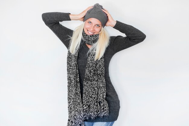 Friendly woman in warm clothes posing for camera