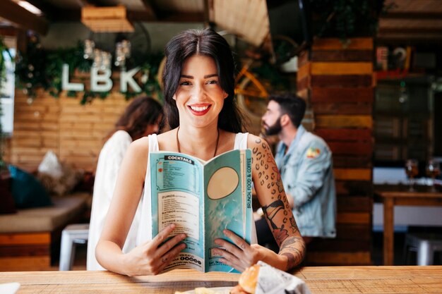 Friendly woman with menu