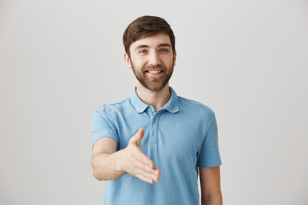 Friendly young bearded man posing