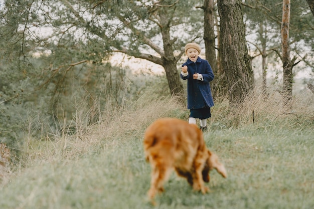 Friends are having fun in the fresh air. Child in a blue coat.