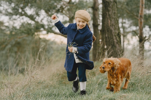 Friends are having fun in the fresh air. Child in a blue coat.