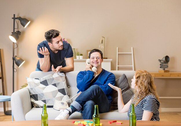 Friends arguing while man talks on phone