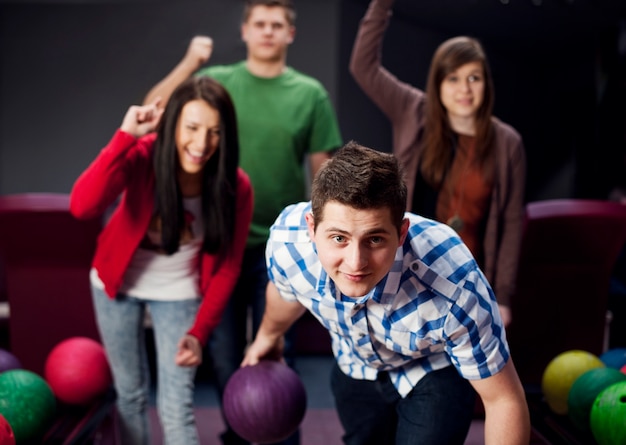 Friends bowling together