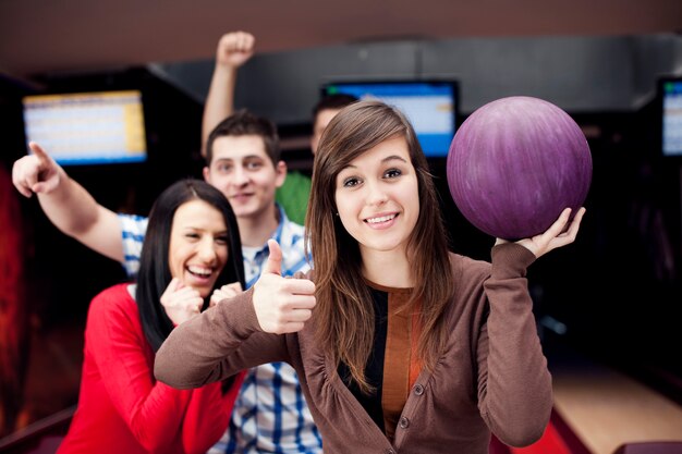 Friends bowling together