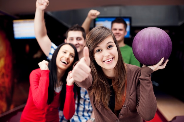 Friends bowling together