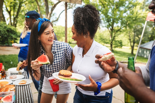 Friends celebrating and eating at a tailgate party