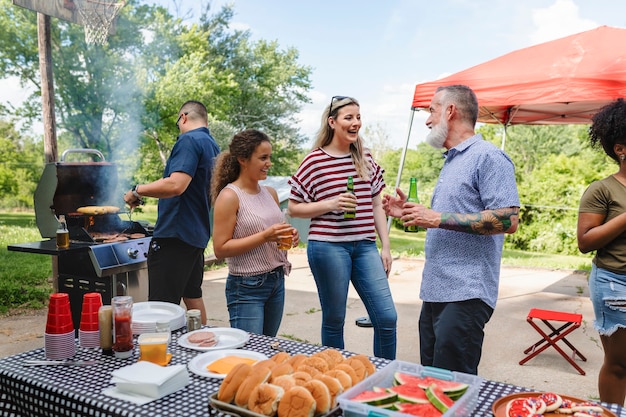 Friends celebrating and eating at a tailgate party