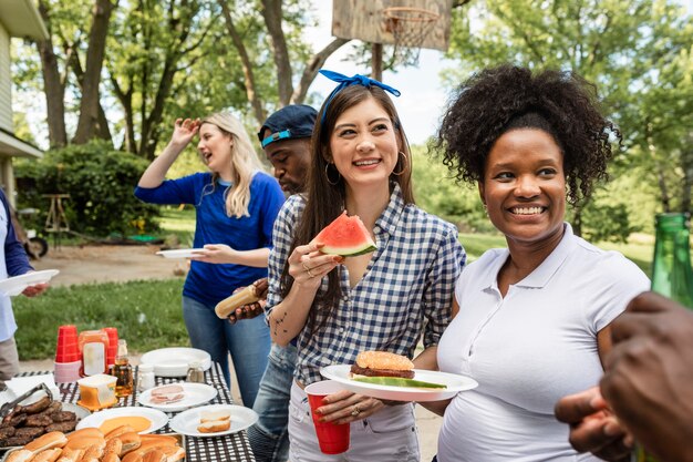 Friends celebrating and eating at a tailgate party