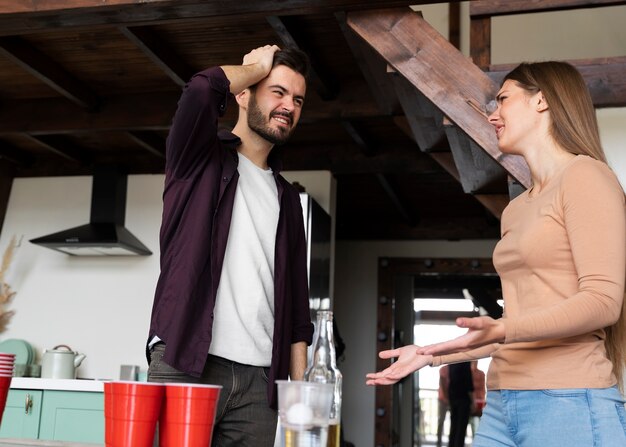 Friends chatting over a beer pong game