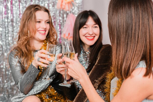 Friends chatting on a sofa at a new year party