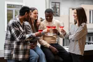 Free photo friends cheering glasses of wine at a gathering