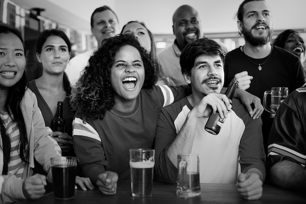 Free photo friends cheering sport at bar together