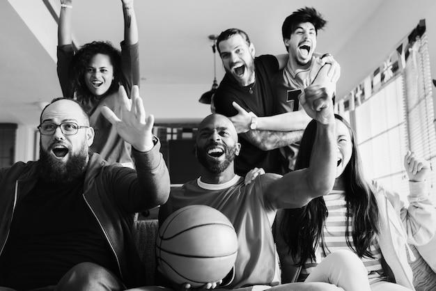 Friends cheering sport league together