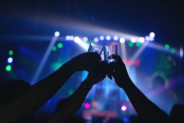 Friends clinking drink glasses in a modern bar