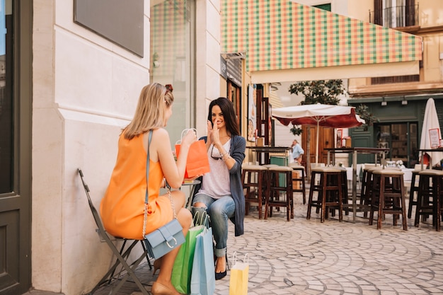 Friends in coffee shop with bags