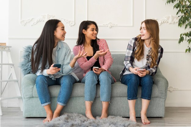 Friends communicate sitting on couch