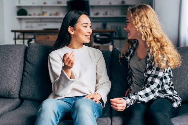 Friends communicate sitting on couch