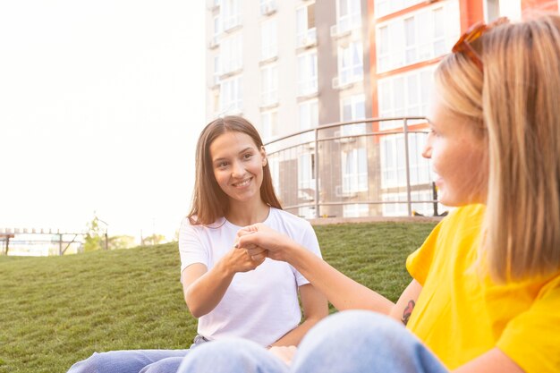 Friends communicating with each other using sign language