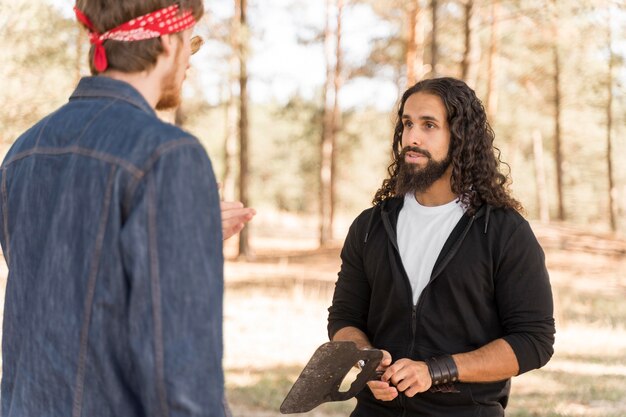 Friends conversing outdoors over barbecue