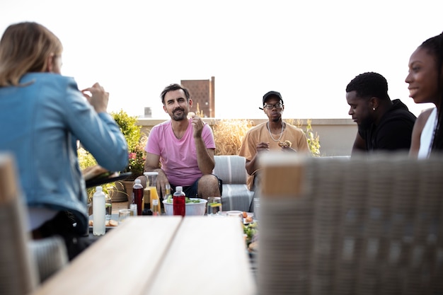 Free photo friends cooking together on a barbecue