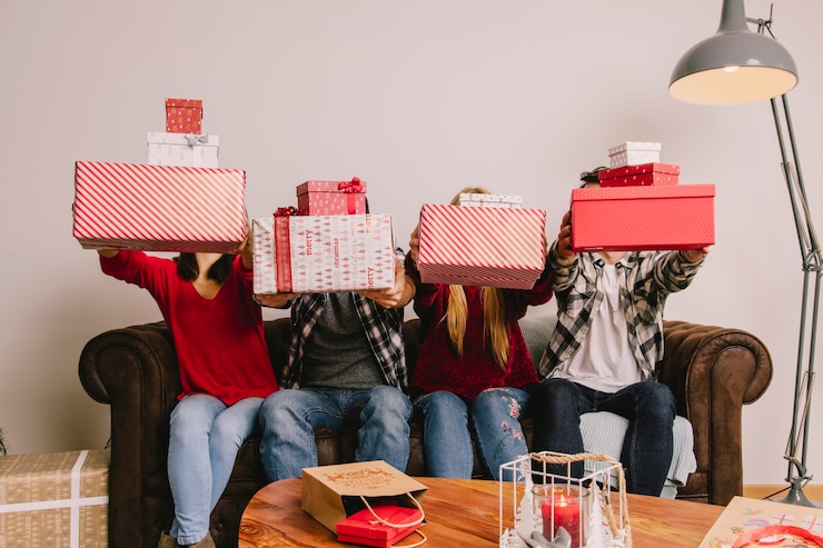 Free Photo friends on couch gifting each other