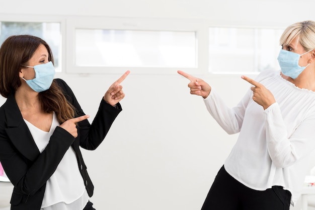 Friends and coworkers wearing protection mask at work