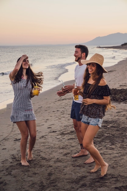 Friends dancing at the shoreline