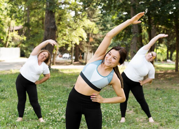 Friends doing stretching exercises in the park