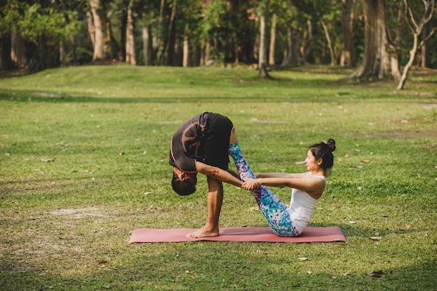 Friends doing yoga in the nature