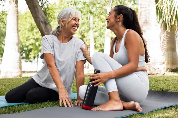 Friends doing yoga together in park