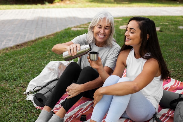 Foto gratuita amici che fanno yoga insieme nel parco