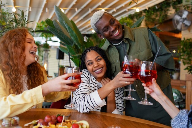 Friends drinking aperol spritz cocktail