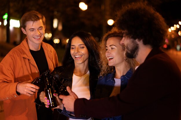 Friends drinking beer together during a night out