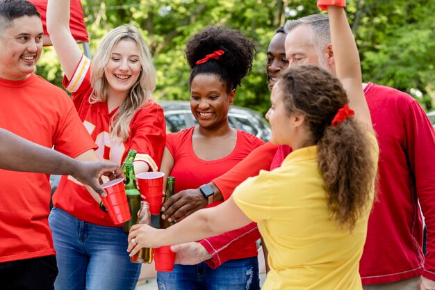 Friends drinking at a tailgate party