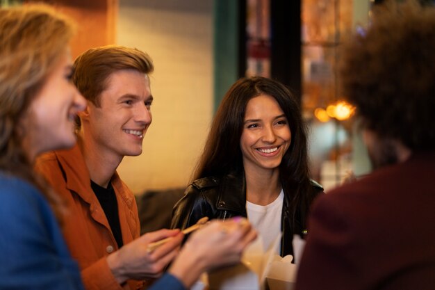 Friends eating chinese food together during a night out