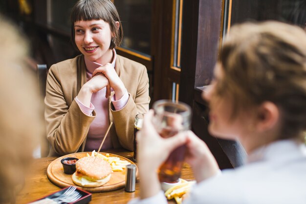 Friends eating and conversating in restaurant