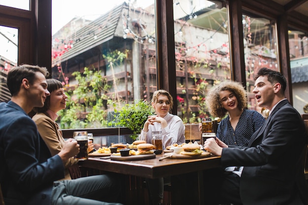 Friends eating and conversating in restaurant