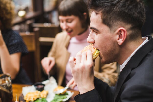 Friends eating and conversating in restaurant